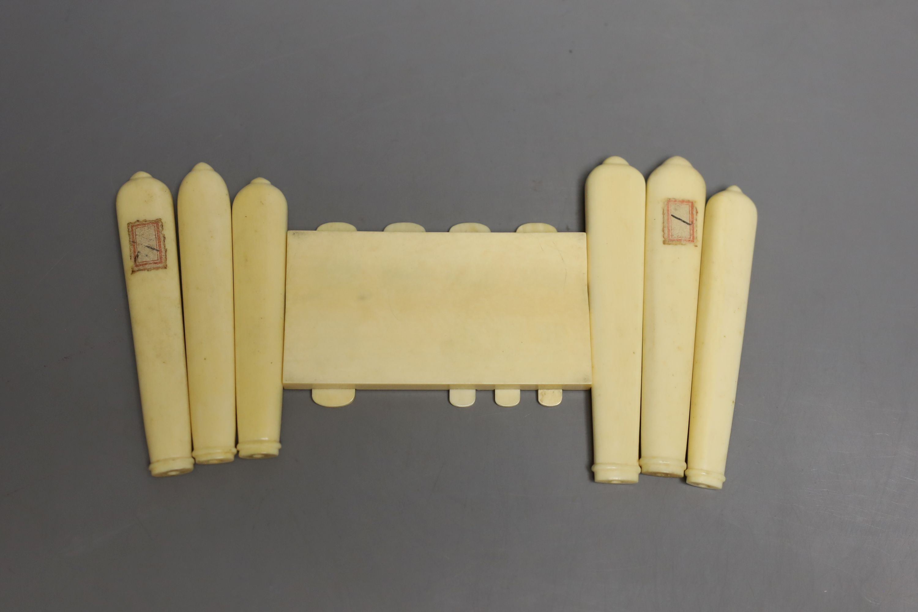 A carved ivory Japanese bezique marker and six Shibayama style ivory handles, Meiji period marker 9cms wide x 6 high.